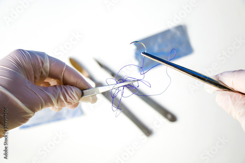 Surgery operation equipment, scalpel, knife, needle and suture. Studio shoot. photo