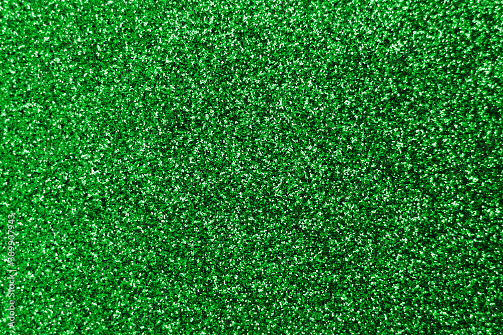 Fototapeta premium Sparkle splash and lens flare on green emerald shiny trendy background. Sequins. Festive background for your projects. Blurred green festive bokeh lights. Christmas festive time concept on background.