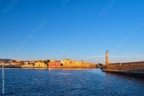 Iconic view of Old Venetian harbour , Chania, Crete, Greece in morning. Famous old port Lighthouse, Maritime museum, Firka fortress. Golden hour shot