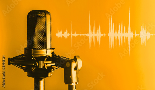 Microphone with waveform on orange background, broadcasting or podcasting banner