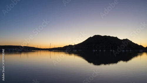 Dawn timelapse at Gariep Dam showing reflected sky and gentle motion of moored boats as light grows in the morning sky. photo