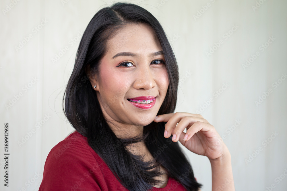Portrait of beautiful Asian woman wearing braces. Smile and look at the camera Portrait of beautiful Asian woman wearing braces. Smile and look at the camera