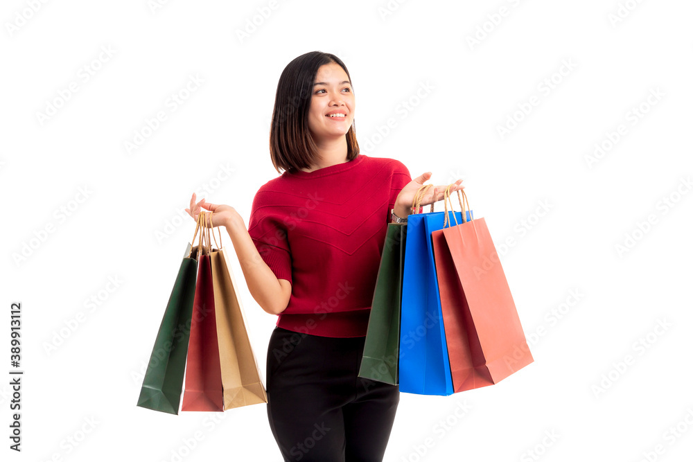 Happy smiling young Asian woman holding shopping bags isolated on white background. Shopping woman in studio shot