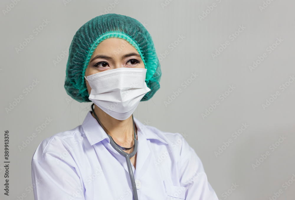 Portrait of doctor woman wearing protective mask standing isolated on gray background Portrait of doctor woman wearing protective mask standing isolated on gray background