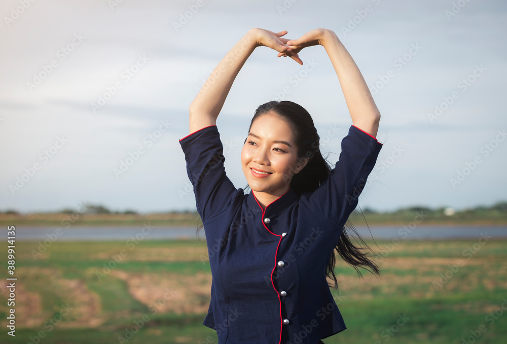 Happy smiling Asian beautiful woman sitting on a wooden bridge outdoors, countryside Happy smiling Asian beautiful woman sitting on a wooden bridge outdoors, countryside