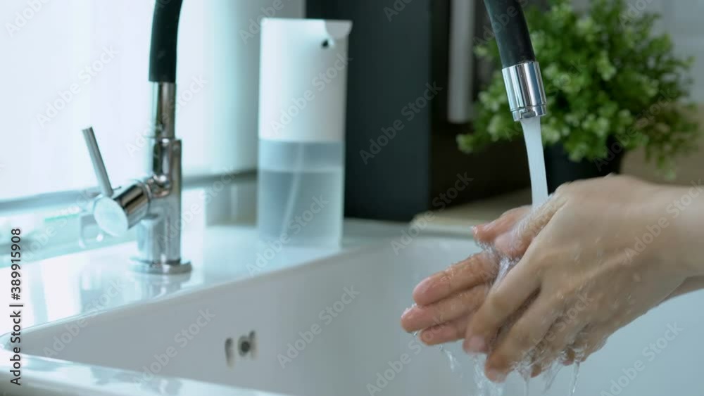 Asian woman washing her hands by using liquid soap foam from automatic soap dispenser. Asian woman washing her hands by using liquid soap foam from automatic soap dispenser.