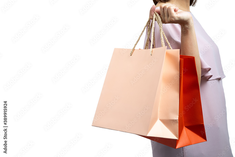 Portrait of beautiful woman wearing casual dress and holding colorful shopping bags isolated on white background with clipping path