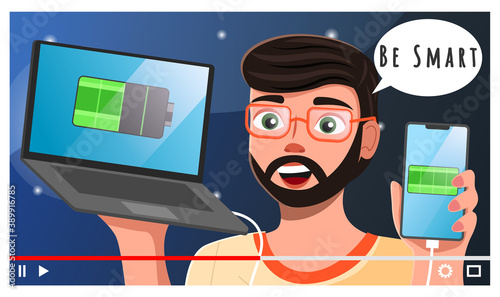 Young bearded guy in glasses, close-up, shoots video for subscribers. Man with smartphone and charger, training master class about smartphones and electronics. Charged battery image. Blogger, streamer