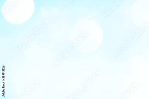 Bokeh light on blue background  sky with circle glitter light blue. Snow abstract soft glowing with vivid bright light and bokeh blur effect. 