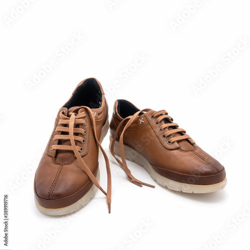 Women's demi-season lace-up low shoes. Natural brown leather, flat grooved sole. Isolated on white background.