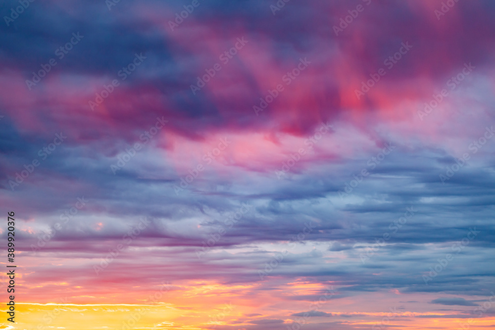sunny sunset in cloudy blue sky with flame tongues with blurry background, used as a background or texture, soft focus