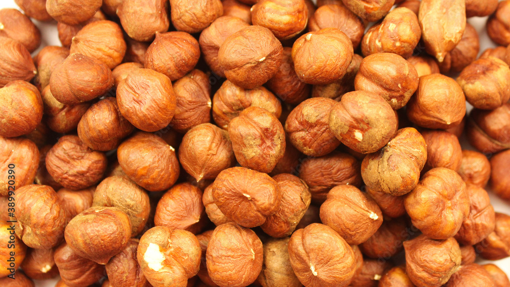 Brown dried peeled hazelnuts. Nut background