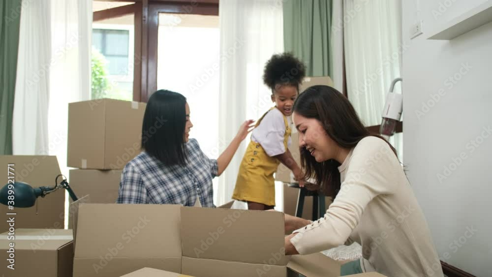 Happy asian women LGBT lesbian couple holding boxes entering new modern house.family unpacking boxes. Happy asian women LGBT lesbian couple holding boxes entering new modern house.family unpacking boxes.