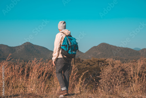 Soft focus blur Asian young men 25-30 year selfie standing Turn around hiking joy with mountain blue sky landscape nature hiking outdoor at reservoir MEATIP Lamphun Thailand