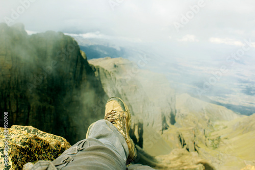 Man resting on top of the mountain after hiking.