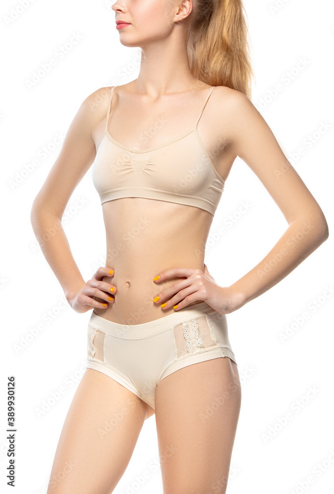 Obraz premium Healthful, belly. Beautiful female model on white background. Beauty, cosmetics, spa, depilation, diet and treatment, fitness concept. Fit and sportive, sensual body with well-kept skin in underwear.