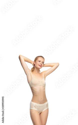 Vertical flyer. Beautiful female model on white background. Beauty, cosmetics, spa, depilation, diet and treatment, fitness concept. Fit and sportive, sensual body with well-kept skin in underwear.
