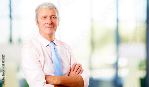 Senior man wearing shirt and thie while looking at camera and smiling