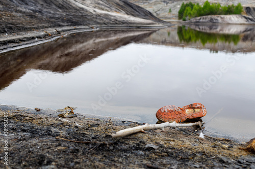 shoes are on the edge of a reservoir in a clay quarry