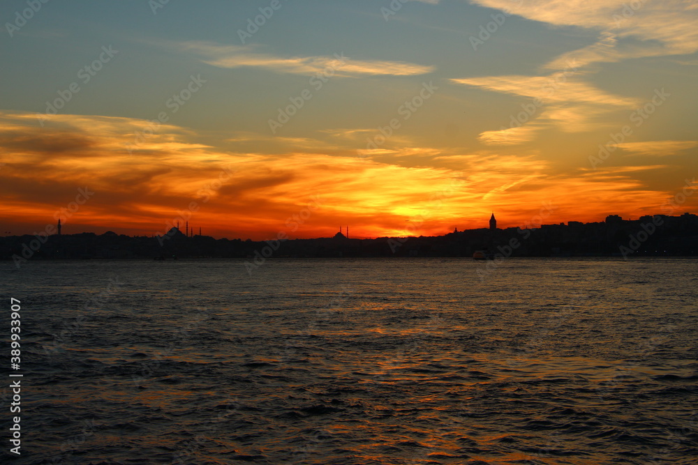 Cityscape of Istanbul at sunset with dramatic orange clouds. Sunset in Istanbul. Istanbul background photo.