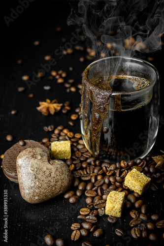 Black freshly aromatic coffee. Breakfast with coffee. Black background. Close up