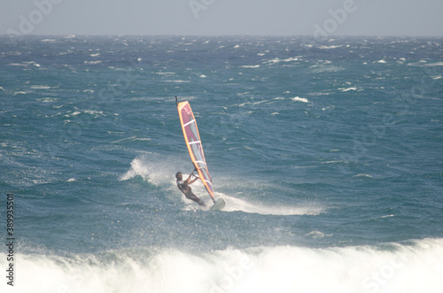 Windsurfer sailing in the coast of Arinaga. Aguimes. Gran Canaria. Canary Islands. Spain.