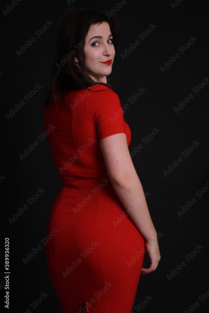 sexy attractive brunette in red skinny dress isolated on black background. studio shoot. emotional actress. . sexy attractive brunette in red skinny dress isolated on black background. studio shoot. emotional actress. .