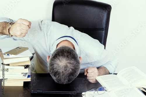 50 years old man in his office , stressed by the situation