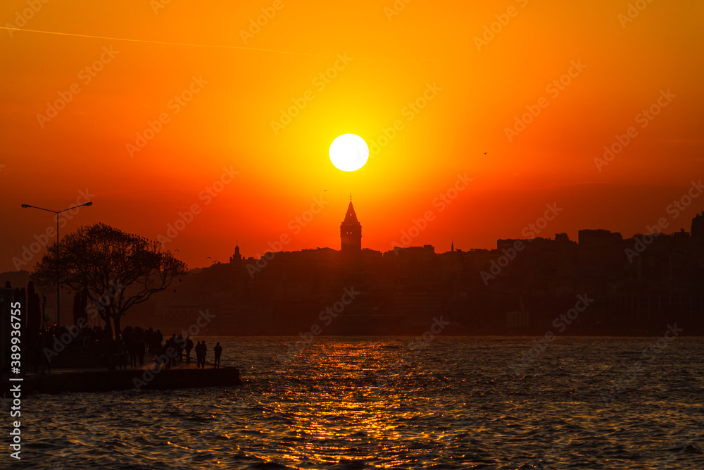 Galata Tower and Sun. Cityscape of Istanbul at sunset. Istanbul sunset background photo. Travel to Istanbul. 