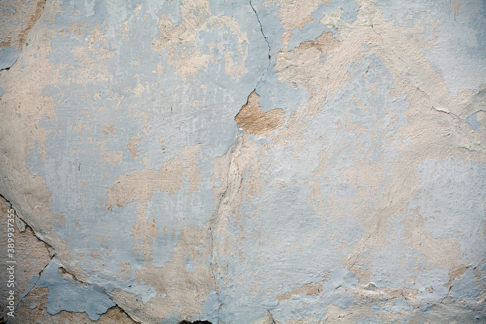The texture of a plaster cracked wall. Stucco material, surface, background. The texture of a plaster cracked wall. Stucco material, surface, background.
