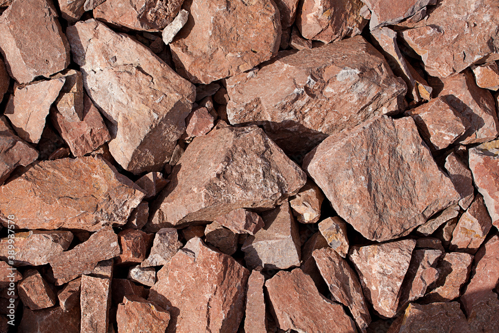 Coarse crushed stone from rock for road construction. Background, material, texture.