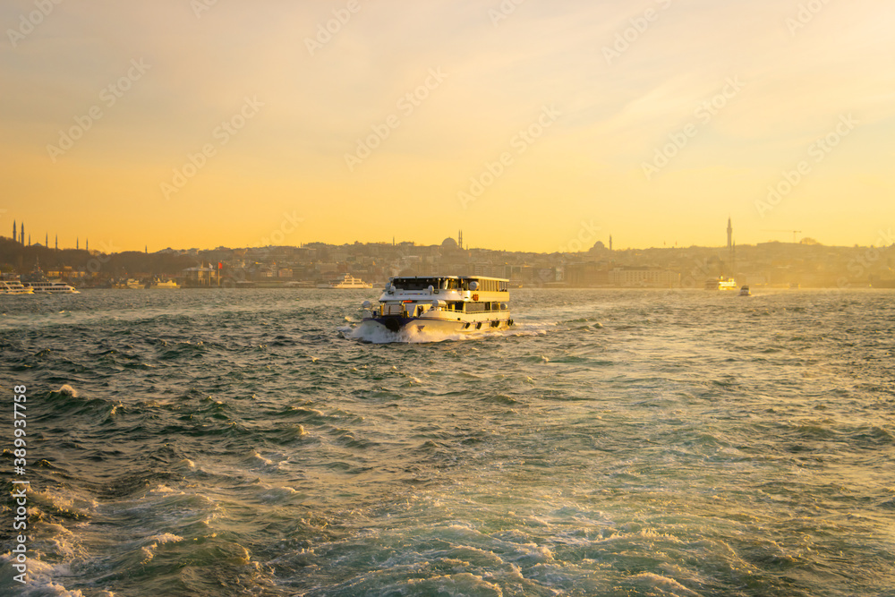 Obraz premium Cityscape of Istanbul and ferries. Istanbul background photo. Sunset in Istanbul. 