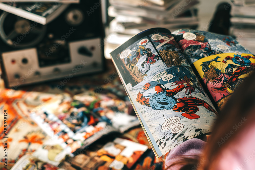 Naklejka premium Person reading comic book at home. Rostov-on-Don, Russia. 20 October 2020