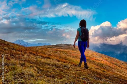 Adventurous Girl Hiking up the Nares Mountain. Dramatic Colorful Sunset Sky Art Render. Taken near Whitehorse, Yukon, Canada.