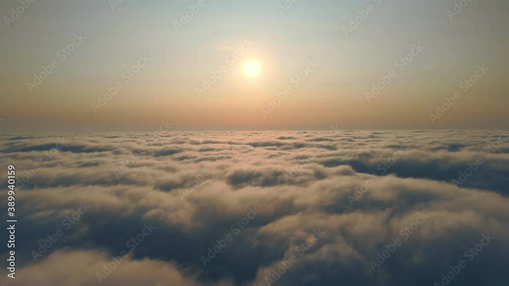 Fabulous sunrise over the clouds. Flight over the morning fog above the sky and sunbeams that illuminate the fog and clouds. Background or texture. Fabulous sunrise over the clouds. Flight over the morning fog above the sky and sunbeams that illuminate the fog and clouds. Background or texture.
