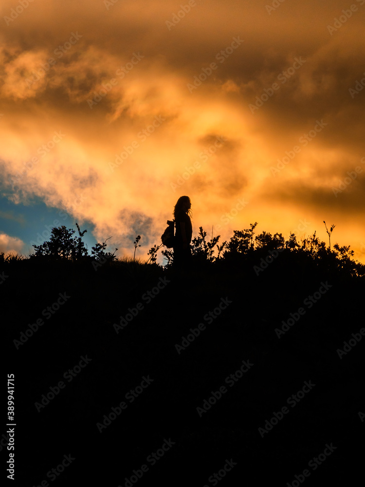 Woman silhouette in a sunset