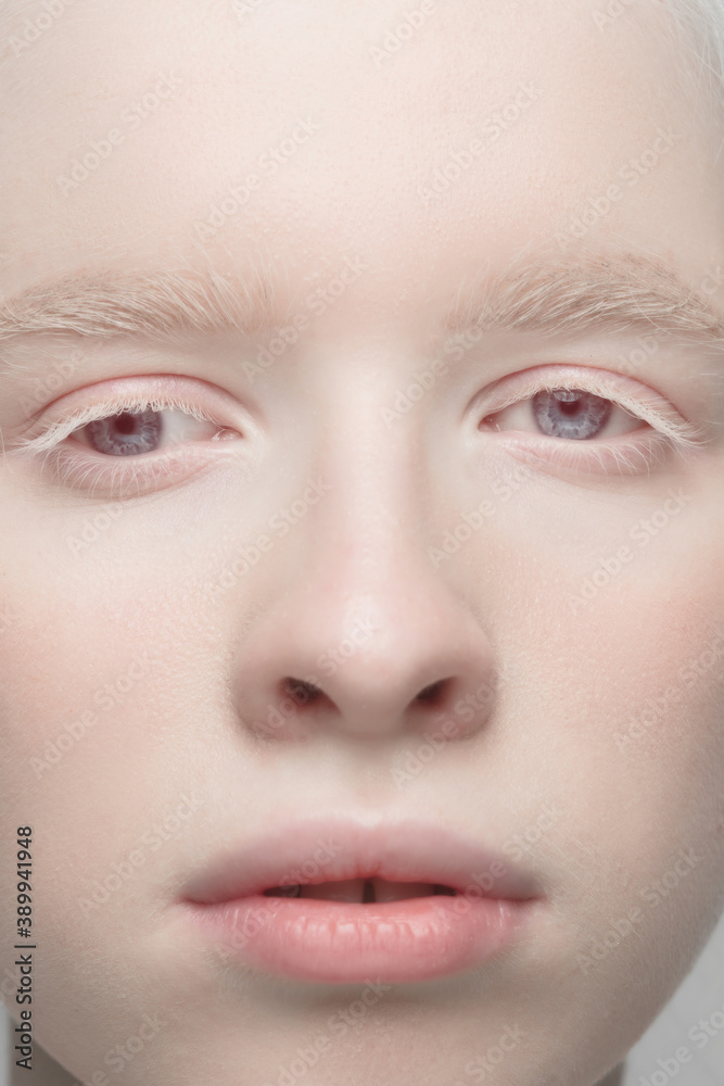 Eyes open. Close up portrait of beautiful albino female model. Parts of face and body. Beauty, fashion, skincare, cosmetics, wellness concept. Copyspace. Well-kept skin, fresh look, details.