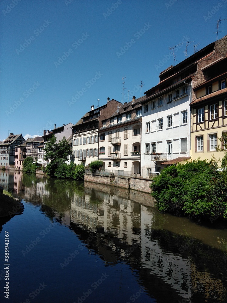 View of the picturesque houses along the River Ill of Strasbourg with reflections in the still river