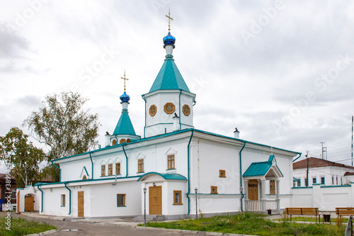 Iverskaya Church in Yeniseisk, an old stone building. Ancient orthodox architecture. Blurry sky with clouds. photo