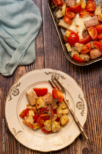 Oven sausage with tomatoes, cheese and crispy bread photo