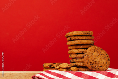 Chocolate chip cookies in stack on red background
