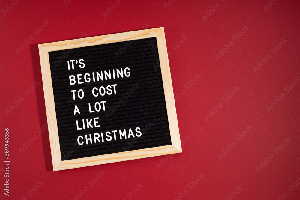 Felt letter board with funny quote text It is beginning to cost a lot like Christmas