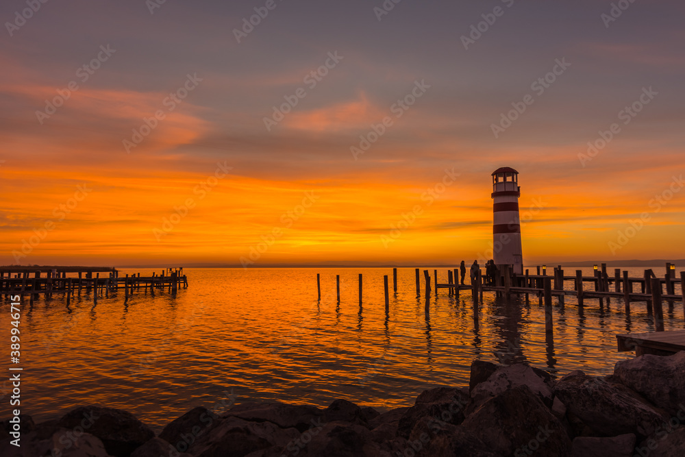 warm sunset at a lake with lighthouse