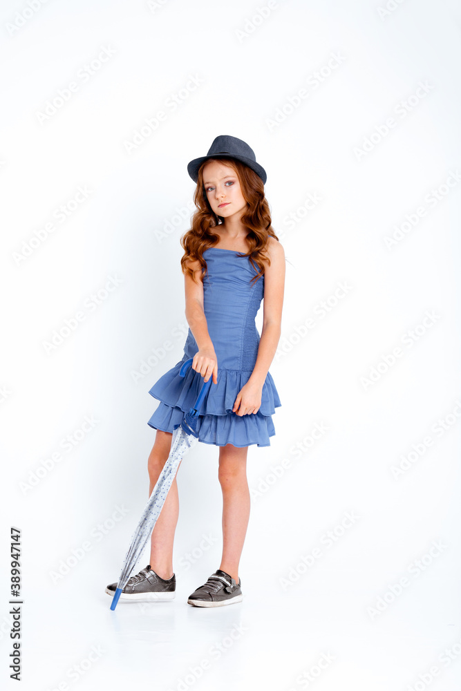 dressed in a light blue dress on spaghetti straps cute little girl on a white background dressed in a light blue dress on spaghetti straps cute little girl on a white background