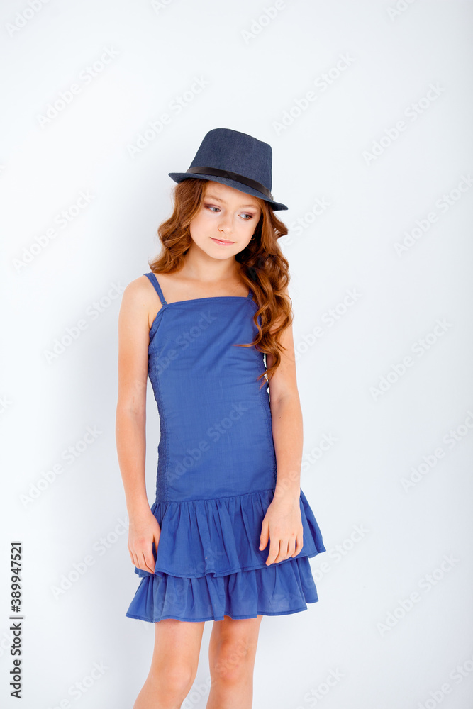 dressed in a light blue dress on spaghetti straps cute little girl on a white background dressed in a light blue dress on spaghetti straps cute little girl on a white background