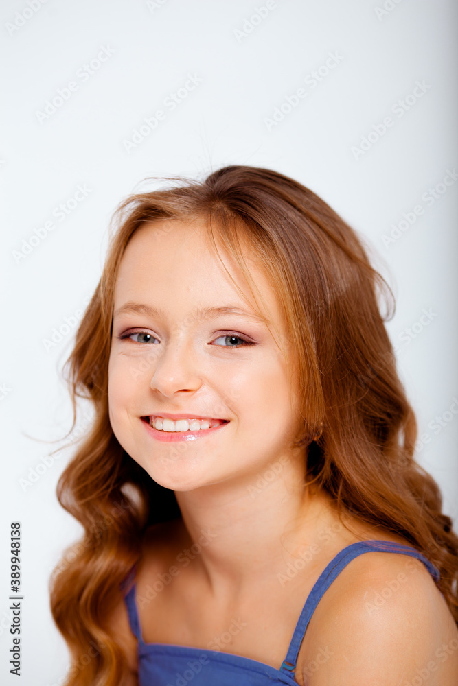 dressed in a light blue dress on spaghetti straps cute little girl on a white background dressed in a light blue dress on spaghetti straps cute little girl on a white background