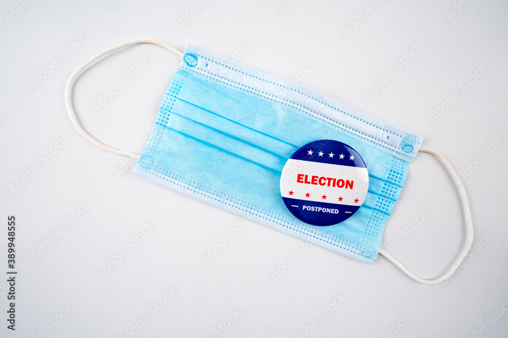 Election postponed text on usa election button and facemask isolated on white background.. Election postponed text on usa election button and facemask isolated on white background..