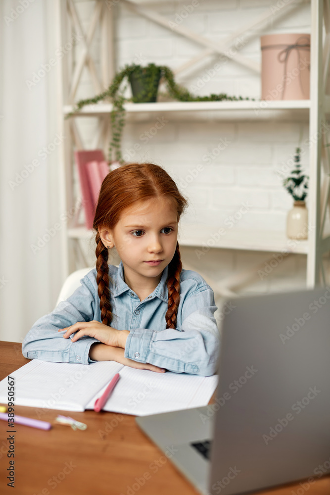 little child girl using laptop for studying online learning system. online lesson at home. social distance during quarantine little child girl using laptop for studying online learning system. online lesson at home. social distance during quarantine