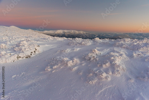 Frosty snowy winter on a mountain range in the evening in the Ukrainian Carpathians © reme80