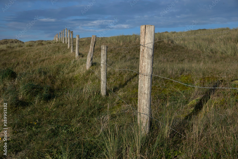 Dunes. Gate. Wire fence. North sea coast. Julianadorp. Netherlands.